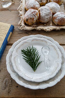 Plate with fir branch, glass bottle stopper and tray with biscuits