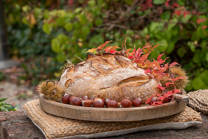 Home-baked bread with chestnuts and vine tendrils