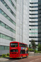 A Red Double Decker Bus On The Street Below An Office Building, Croydon; London, England
