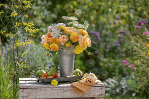 Bouquet of roses (pink), dahlias (dahlia), wild carrot in zinc jug decorated with apricots and pears