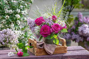 Bouquet of lilac (Syringa vulgaris), rose (Rosa) 'Fräulein Maria', wild garlic flowers and woodruff on garden bench