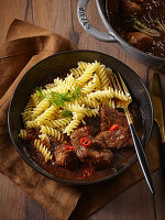 Spicy black beer pork goulash with fusilli