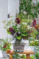 Bouquet of fennel flowers, amaranth foxtail (Amaranthus caudatus), hosta in a vase on the patio