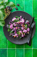 Purple cauliflower salad with blackberries and nuts