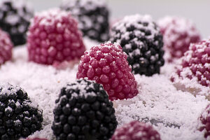 Blackberry and raspberry sweets dusted with icing sugar