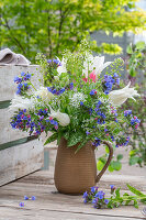 Bouquet of lungwort (Pulmonaria officinalis), shepherd's purse, wild garlic flowers, tulip 'White Triumphator' (Tulipa) in a jug