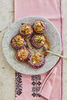 Vegan baked red onions with tofu and herb filling