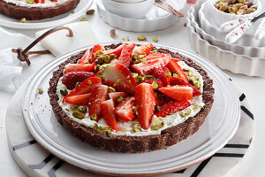 Chocolate tart with mascarpone cheese fresh strawberries and pistachios