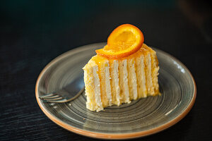 Layer cake served with orange slice