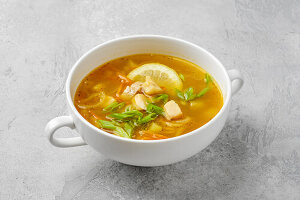 Fish soup with vegetables and spring onions