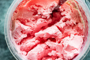 Red textured strawberry ice cream in the jar
