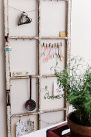 Vintage window frame as wall decoration with kitchen utensils