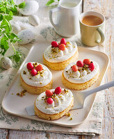 Small Easter cakes with cream and pistachios