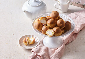 Profiteroles with cream filling and caramel icing