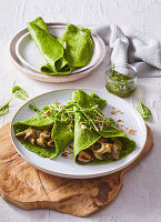 Spinach pancakes with roasted mushrooms and pine nuts