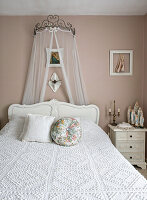 Romantic bedroom with white bed and lace canopy