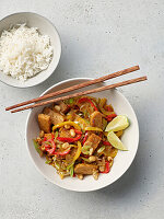 Asian wok-fried vegetables with rice and lime