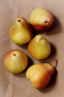 Five pears on brown paper