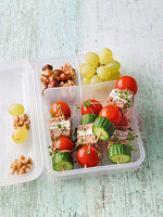 Lunchbox with bread skewers, grapes and nuts