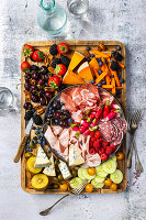 Antipasti platter with cheese, cold cuts and fruit