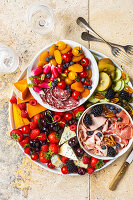 Antipasti platter with cheese, cold cuts and fruit