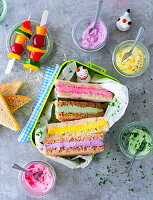 Colourful sandwiches in lunchbox with vegetable skewer
