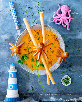 Carrot soup with grissini and sausage octopus