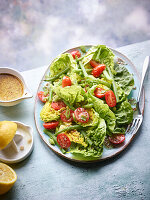 Salad of romaine lettuce, tomatoes and lemon dressing