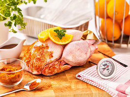 Whole chicken with spices and orange slices