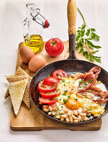 English breakfast with eggs, bacon, beans and tomatoes