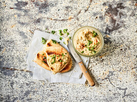 Hummus with flatbread and parsley