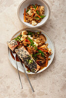 Sesame salmon on a vegetable and oatmeal wok