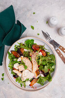 Rocket salad with chicken, plums and feta