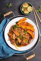 Asian noodles with tempeh and baked pumpkin, cucumber salad