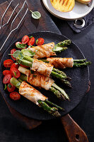 Grilled chicken rolls with green asparagus