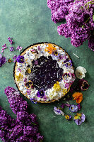 Blueberry tart with meringue and edible flowers