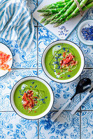 Green asparagus cream soup with bacon chips