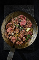 Asian steak flakes with rosemary and thyme, fried in butter