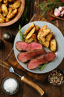 Beef steak with baked potatoes and herbs