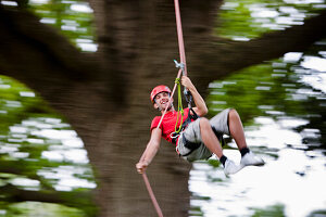 Man dangling from a rope suspended mid air