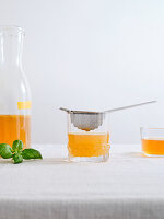 A bottle of homemade fermented kombucha drink with fruit flavour on white background