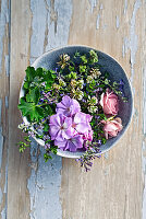 Bowl with edible flowers and herbs