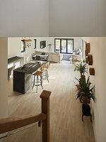 View of open-plan living and kitchen area with kitchen island and wooden floor