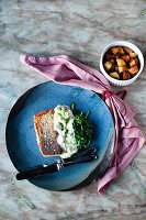 Sous vide salmon fillet with spinach, yoghurt sauce and roast potatoes