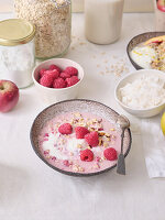 Overnight oats with raspberries, nuts and desiccated coconut