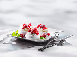 Meringue tartlet with whipped cream and fresh raspberries