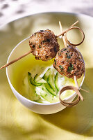 Spicy meatballs on skewers with cucumber tzatziki sauce