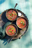 Tomato and chilli soup with cucumber and paprika topping