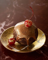 Boule de Noël with golden chocolate glaze and cherries