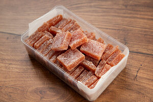 Quince jelly cubes in a plastic box